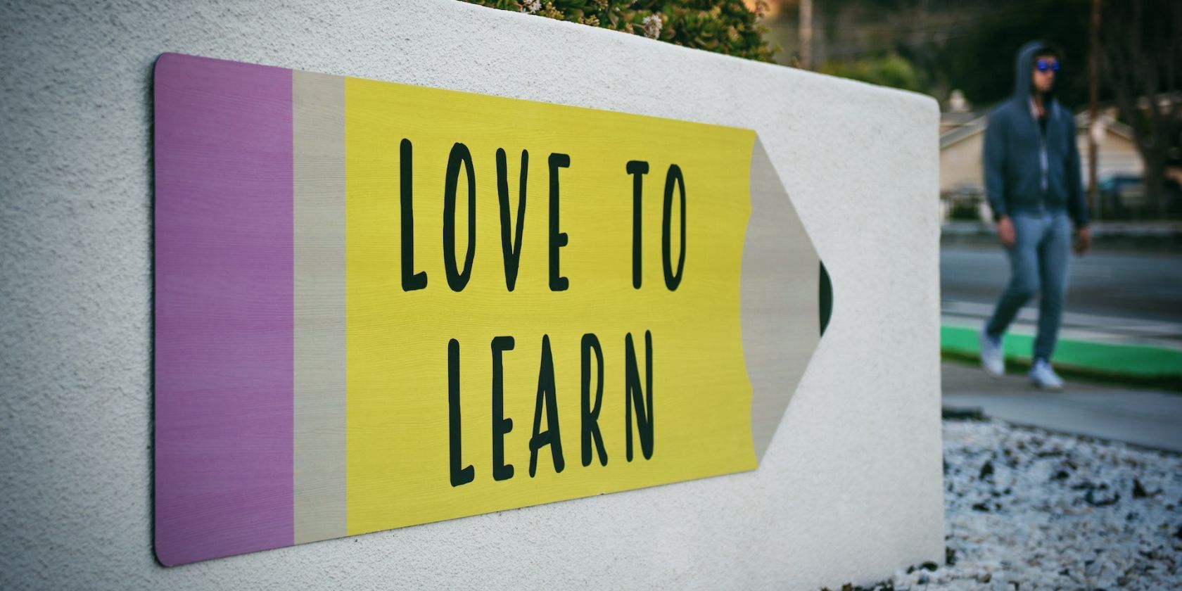 a sign board saying love to learn