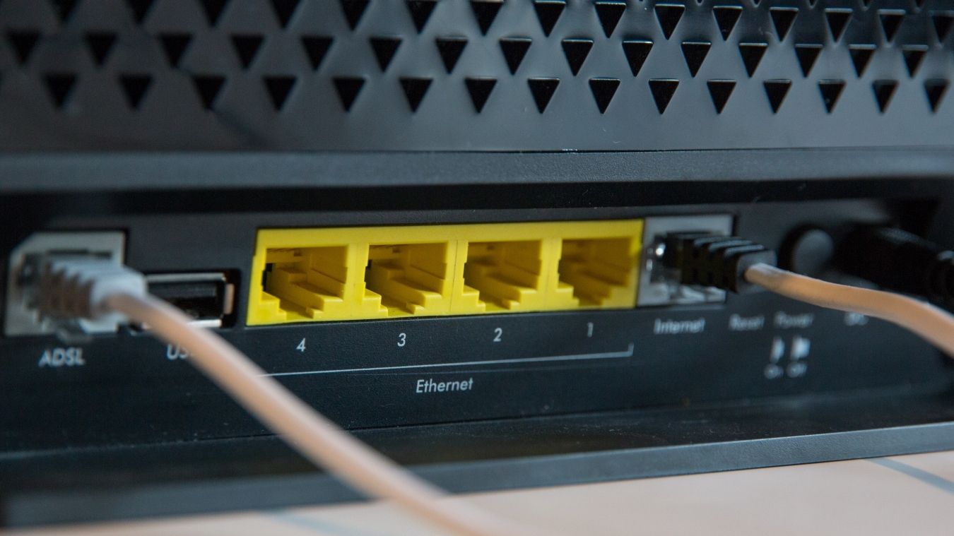 A photograph of four Ethernet ports on the back of a wireless router