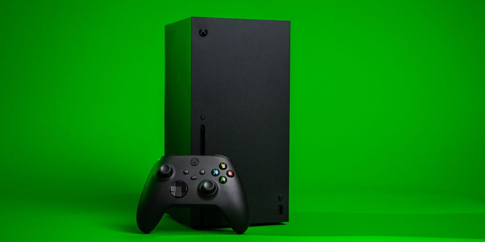 A photograph of an Xbox Series X console and controller against a green background 