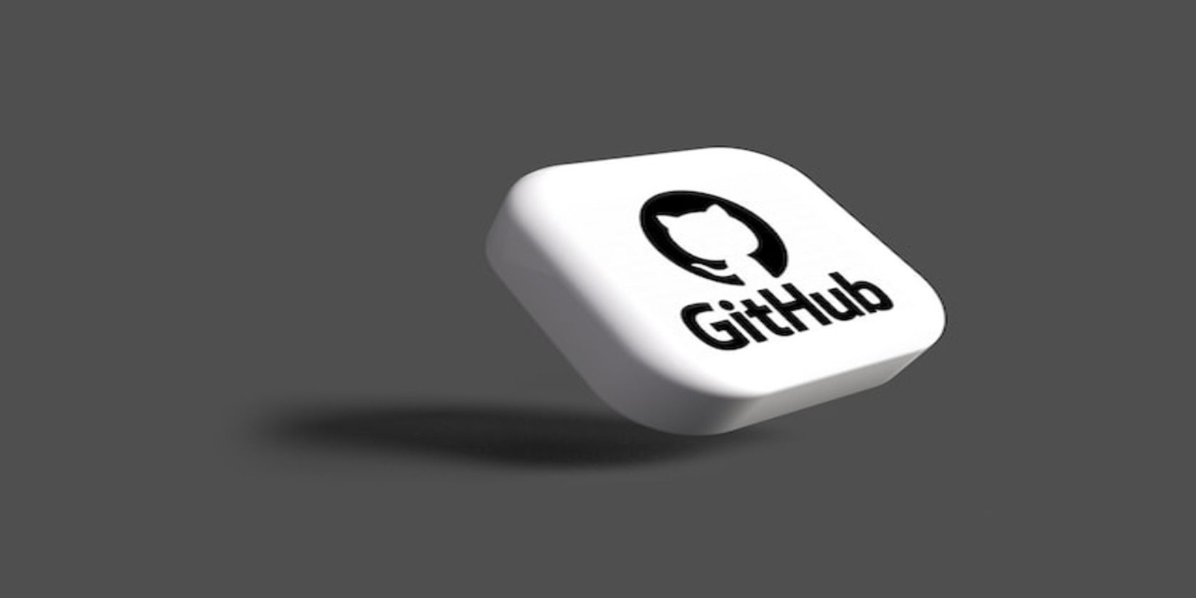 The GitHub logo on a three-dimensional white tile.