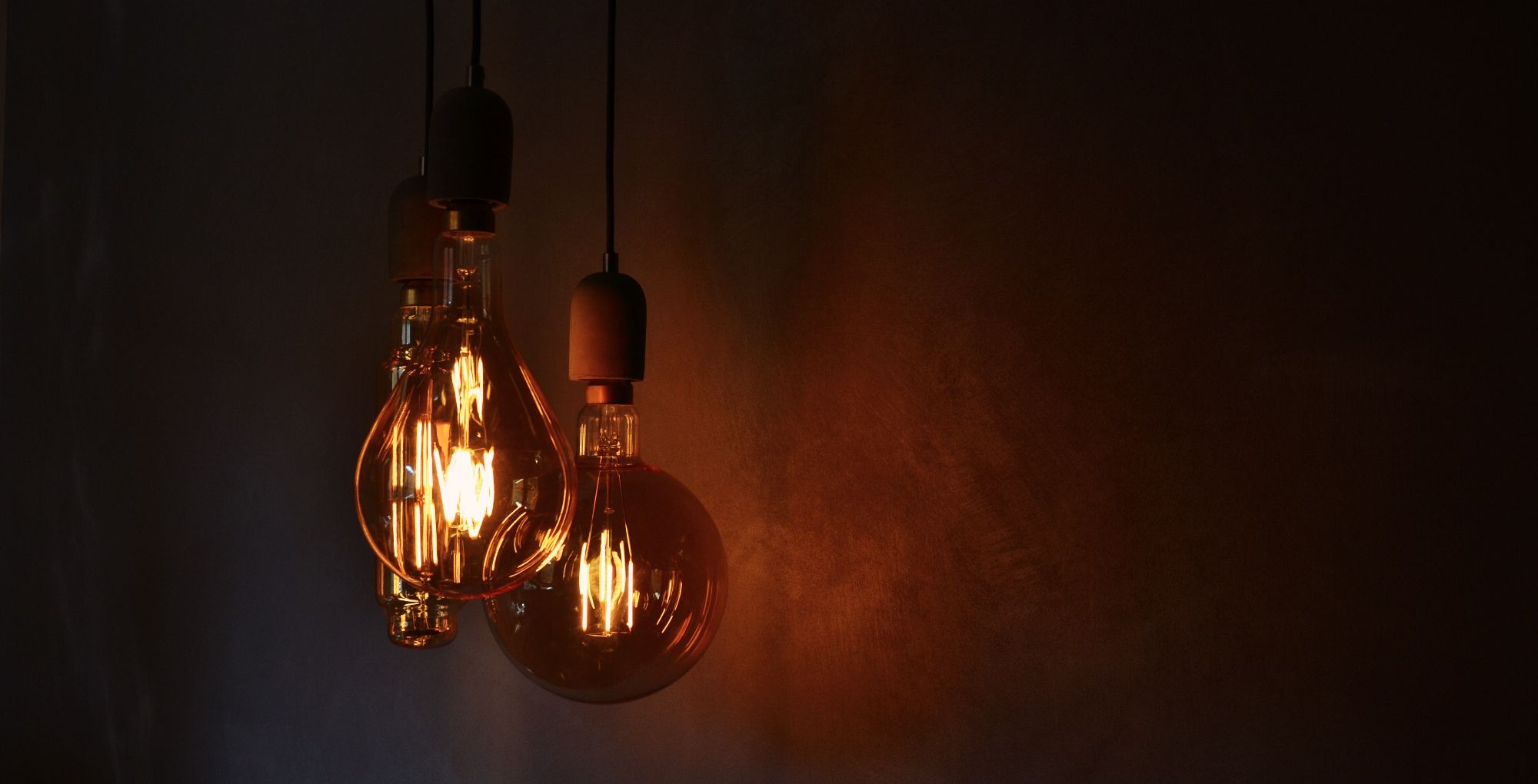 warm tinted light bulbs hanging from ceiling