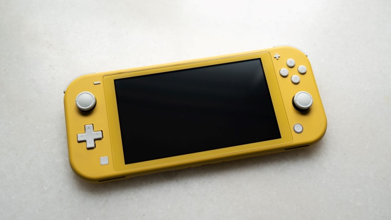 A photograph of a yellow Nintendo Switch Lite console 