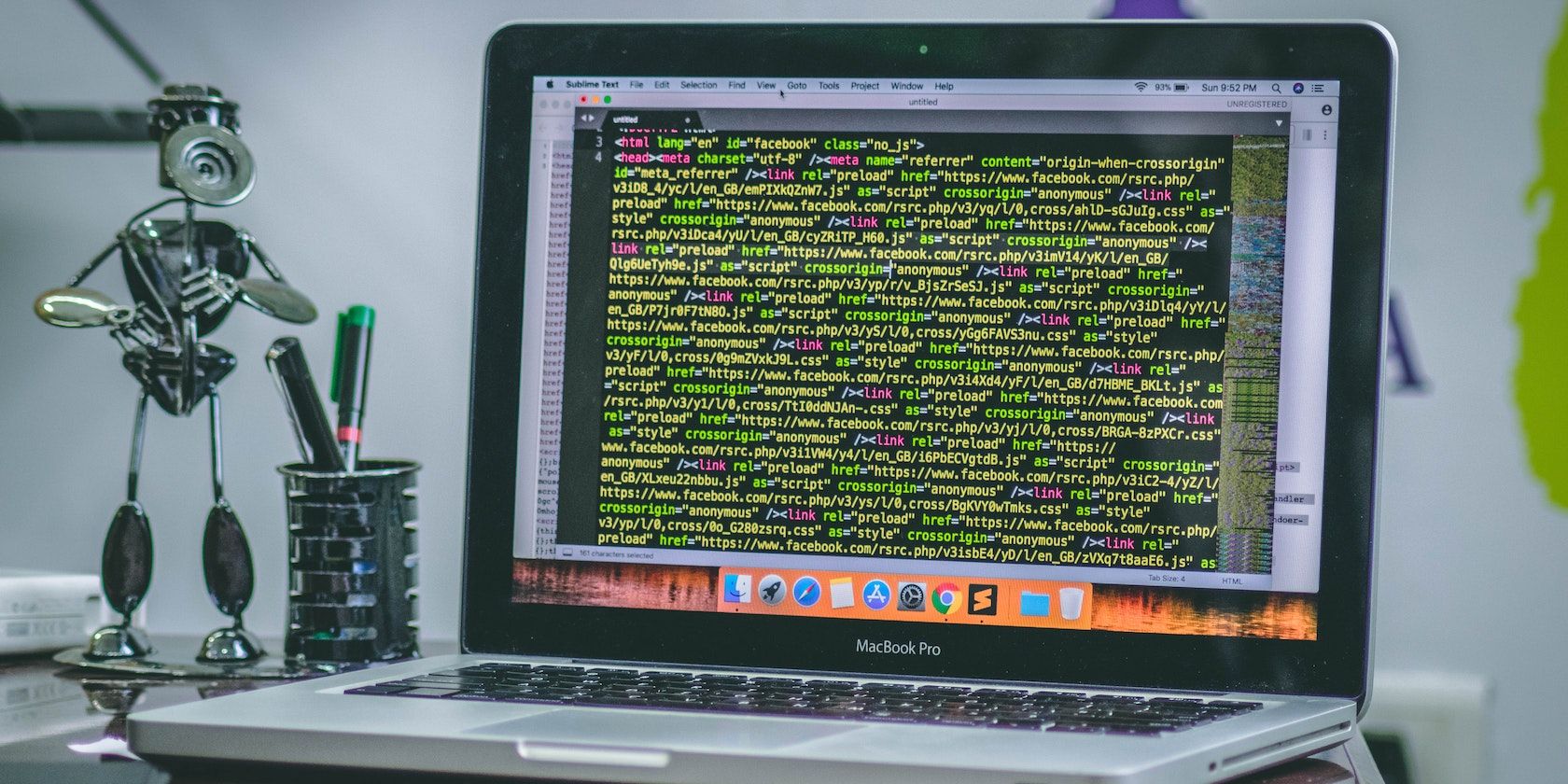 MacBook showing lines of code on its screen
