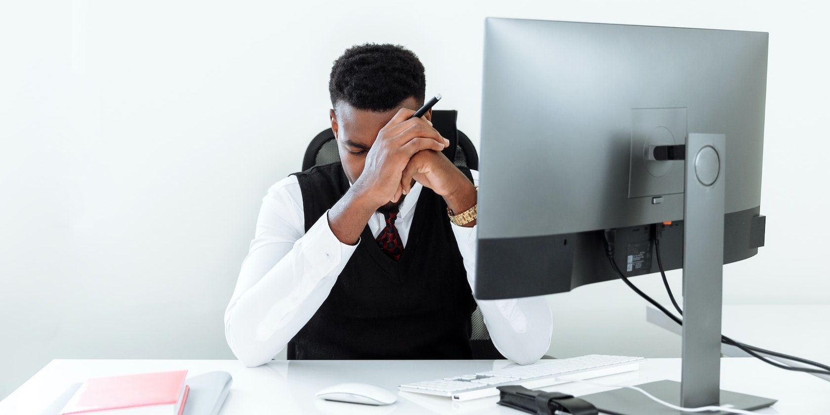 Man looking stressed sitting in front of the pc