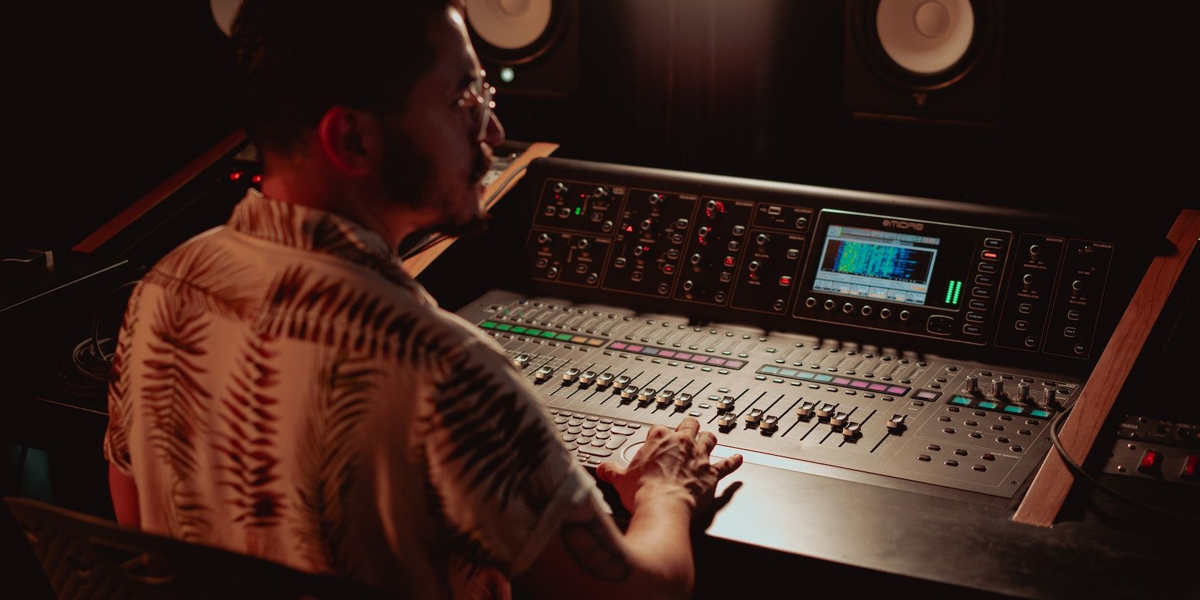 Man working with an audio mixing console