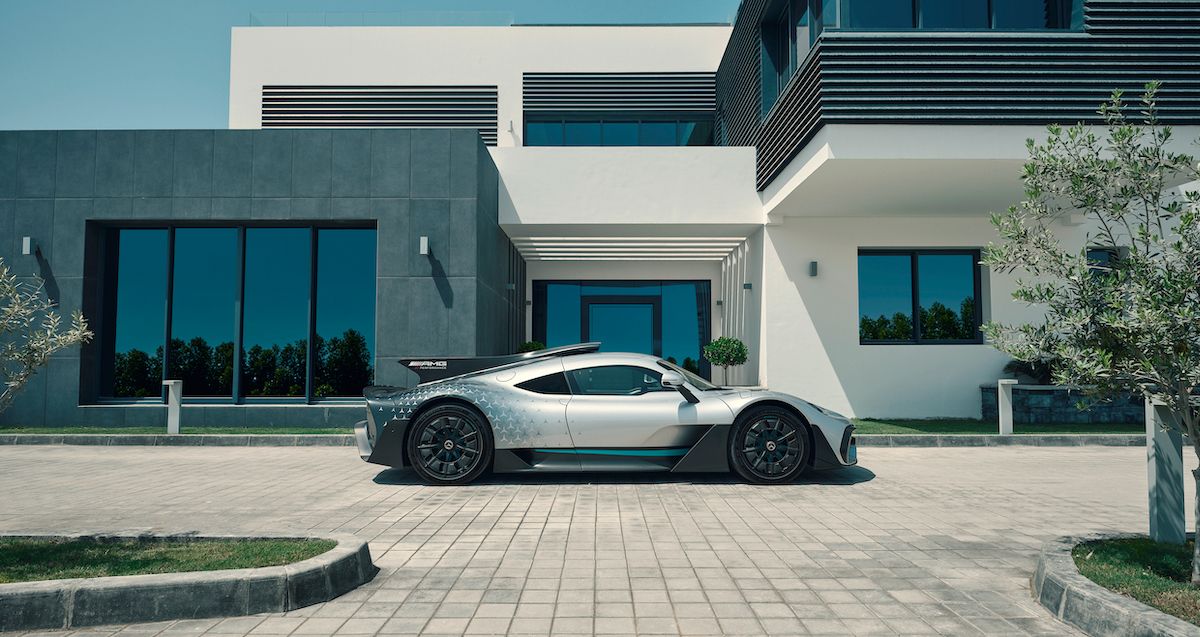 Side profile of a Mercedes-AMG One parked outside a house