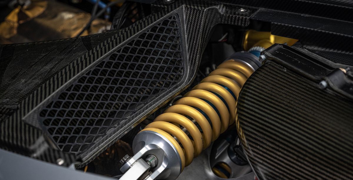 Mercedes-AMG One's gold-colored suspension system surrounded by carbon fiber