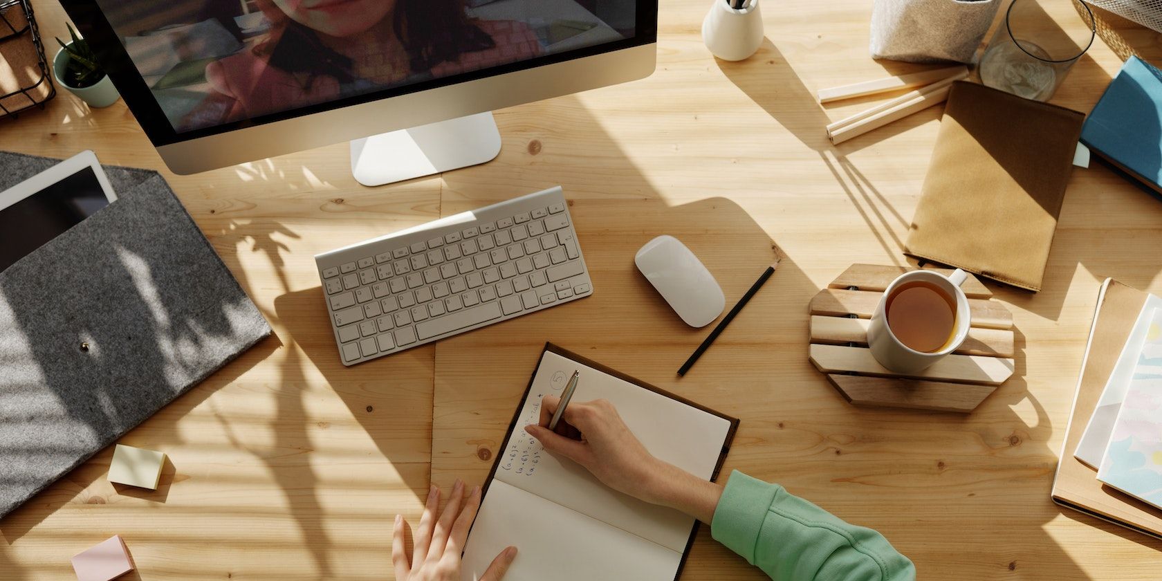 person studying and writing in notebook