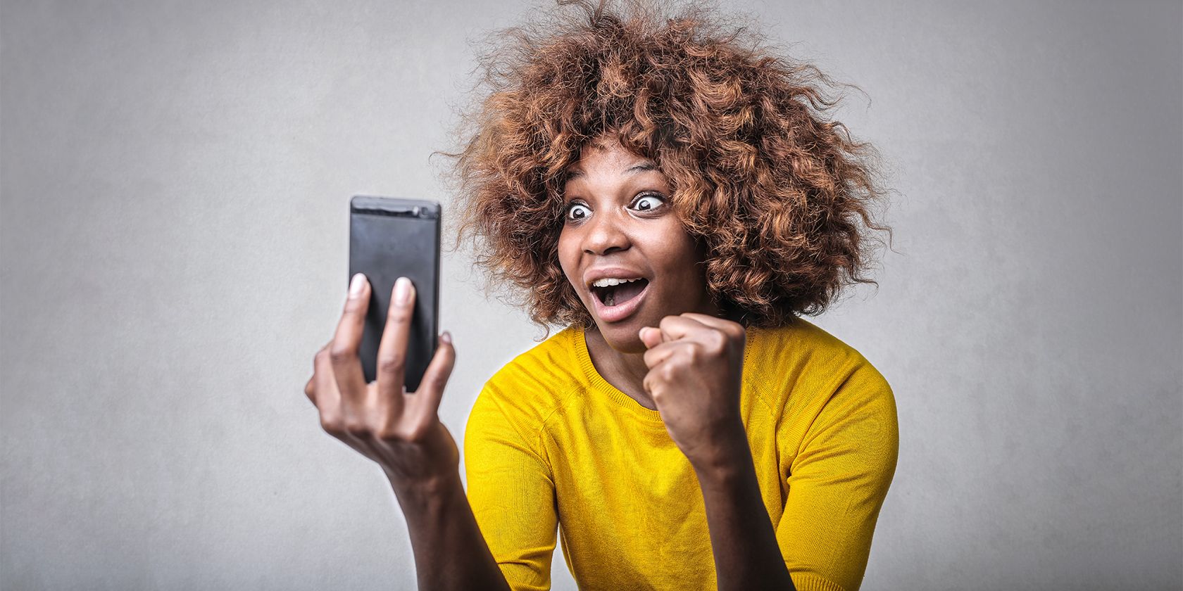 surprised woman with smartphone