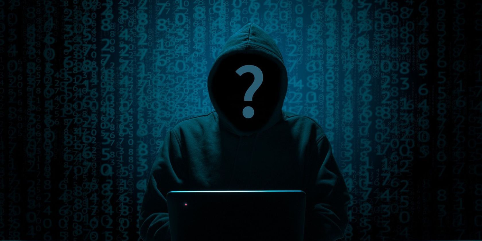 A hooded person sat in front of a laptop with code behind it