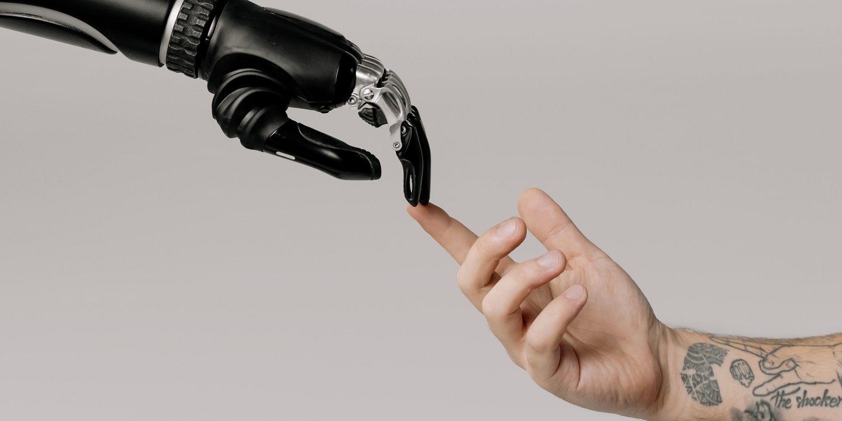 robot and human arms coming together