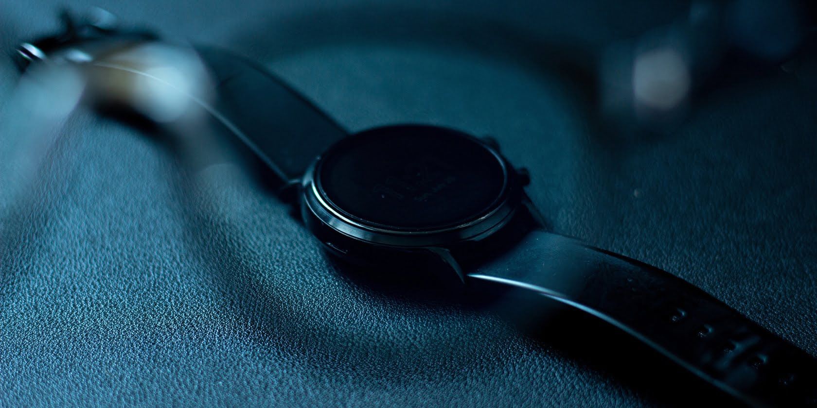 Black smartwatch seen through a pair of glasses