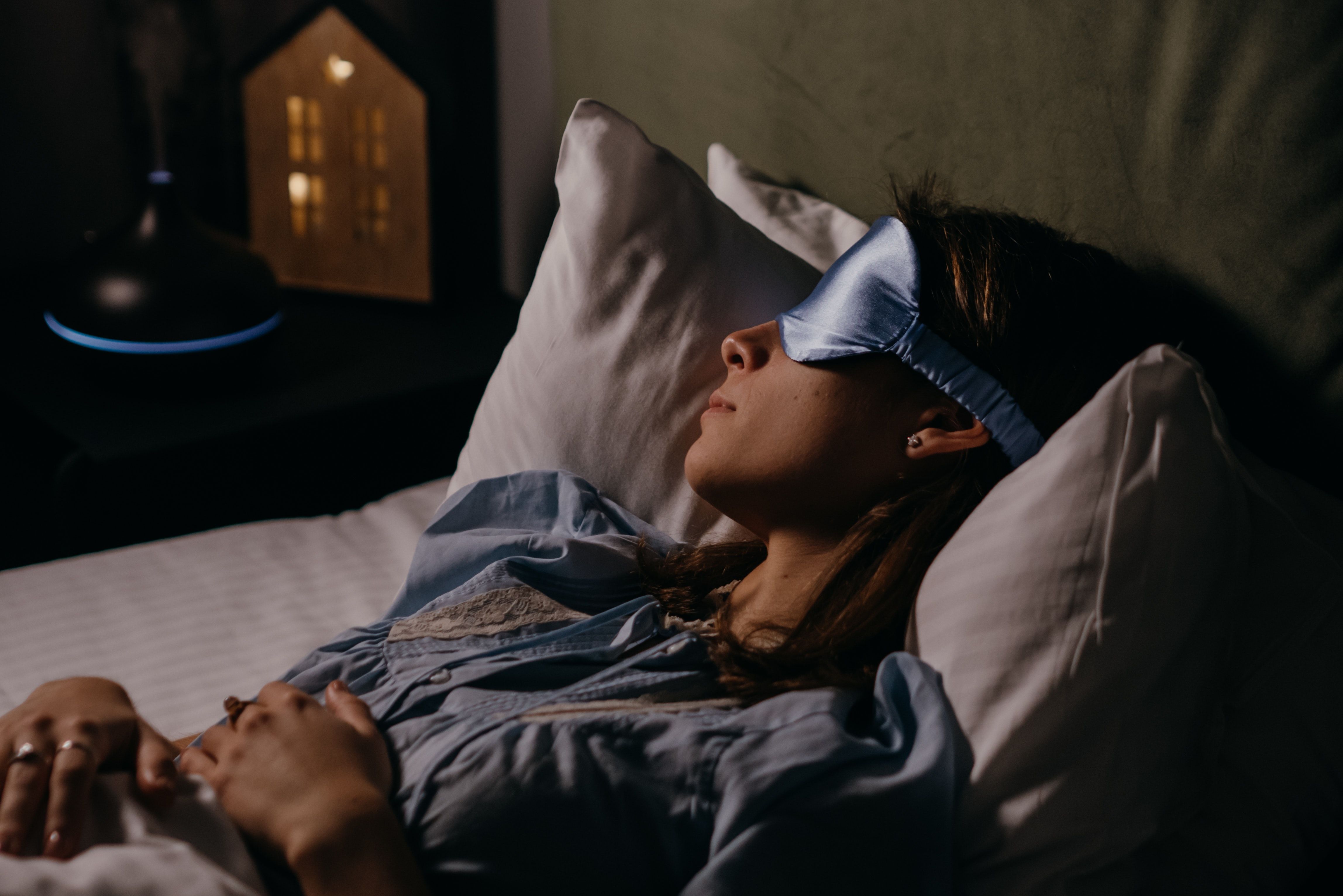 woman wearing smart sleep mask to improve vacation sleep