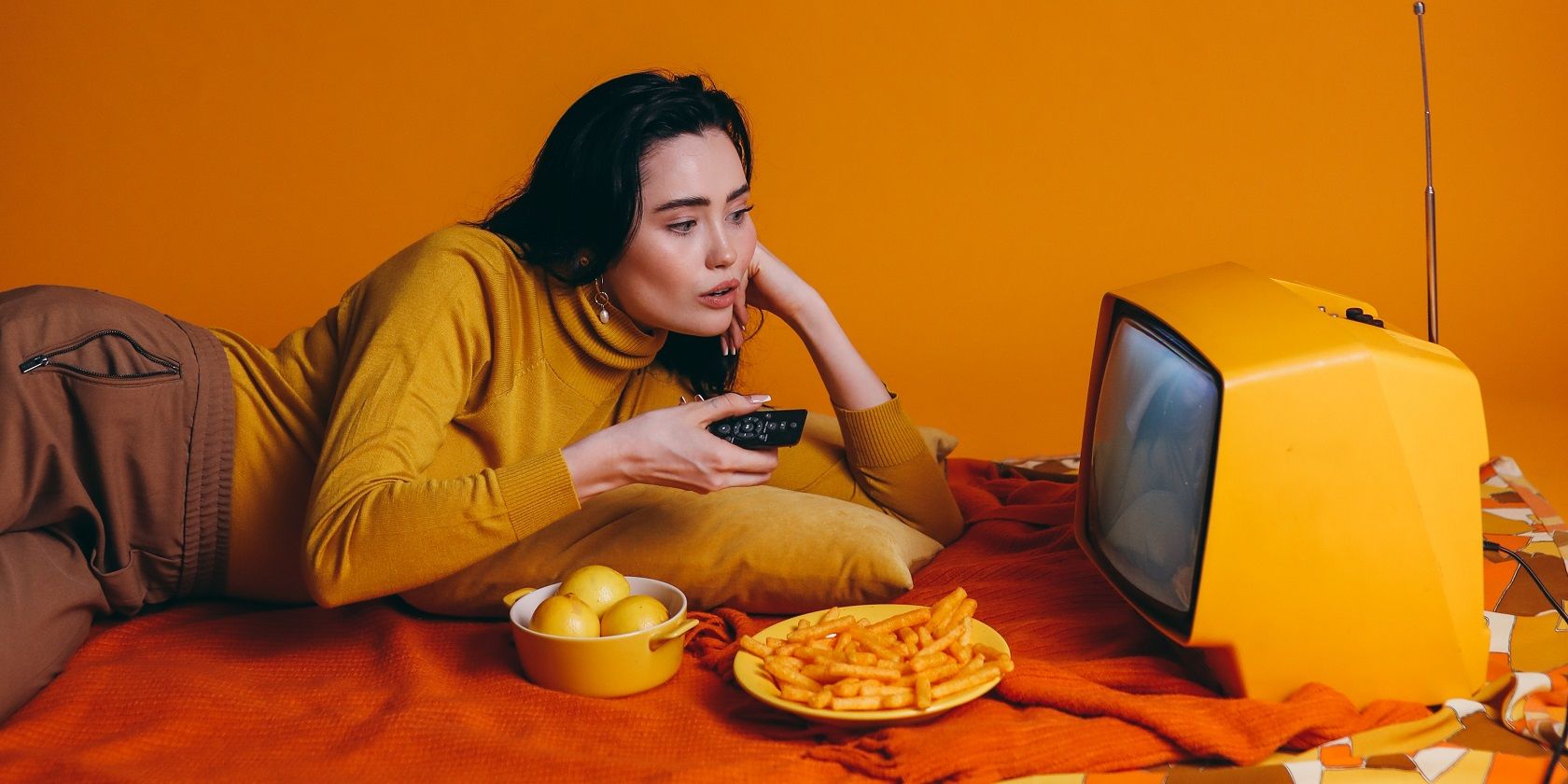 woman with old tv and snacks