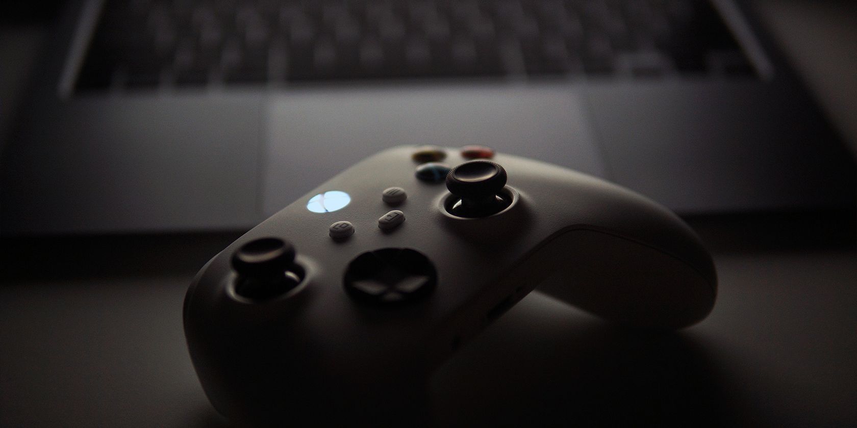 A Gaming Controller in front of an Apple MacBook