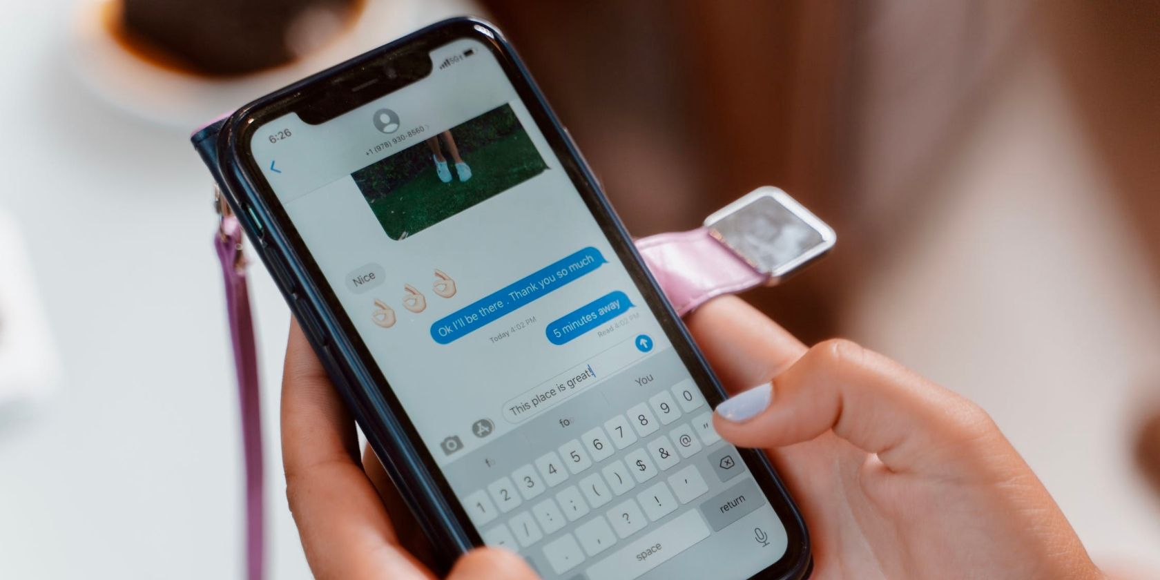 A person typing on an iPhone