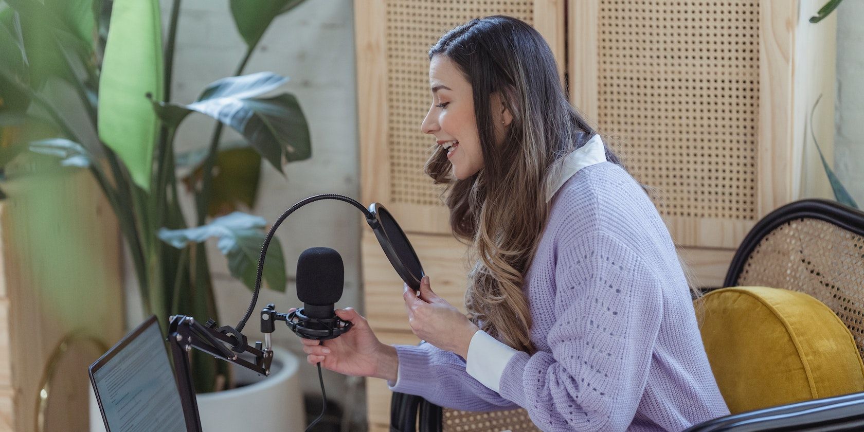A woman recording audio podcast on equipment