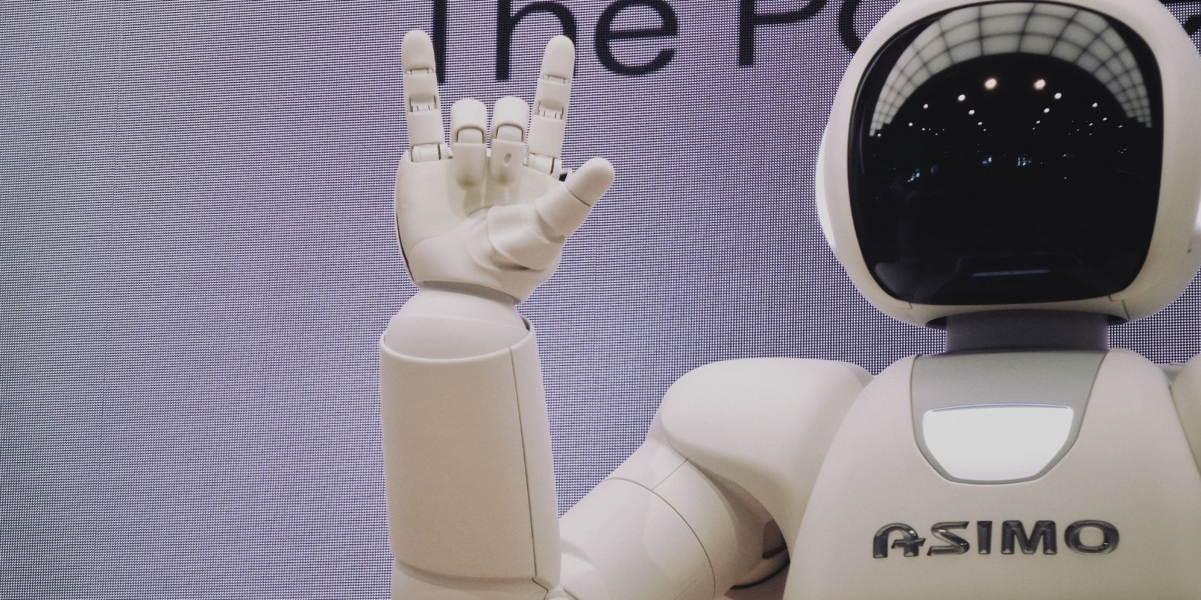 asimo robot showing rock hand gesture