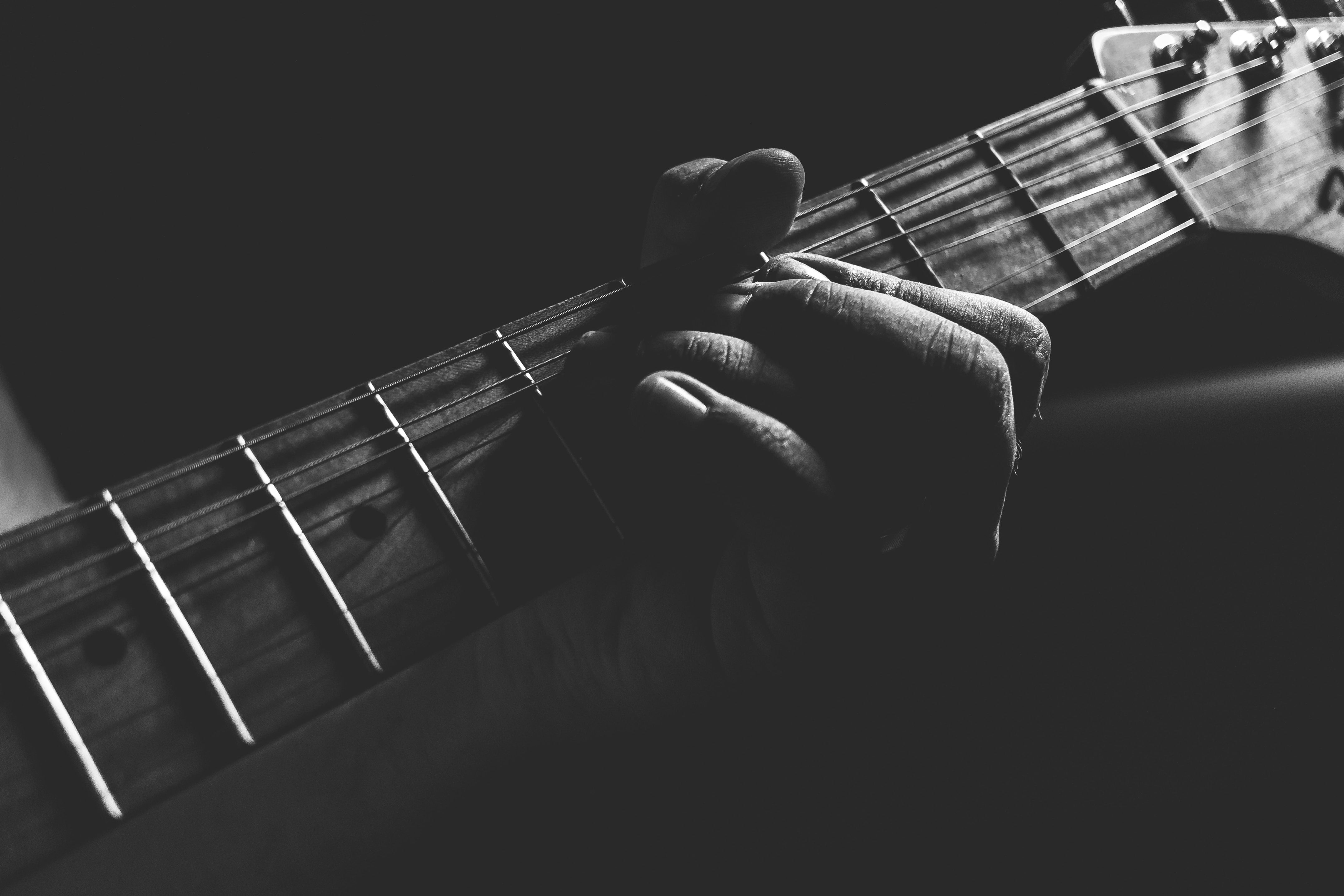Cận cảnh phím đàn của một cây đàn guitar khi một người đang chơi