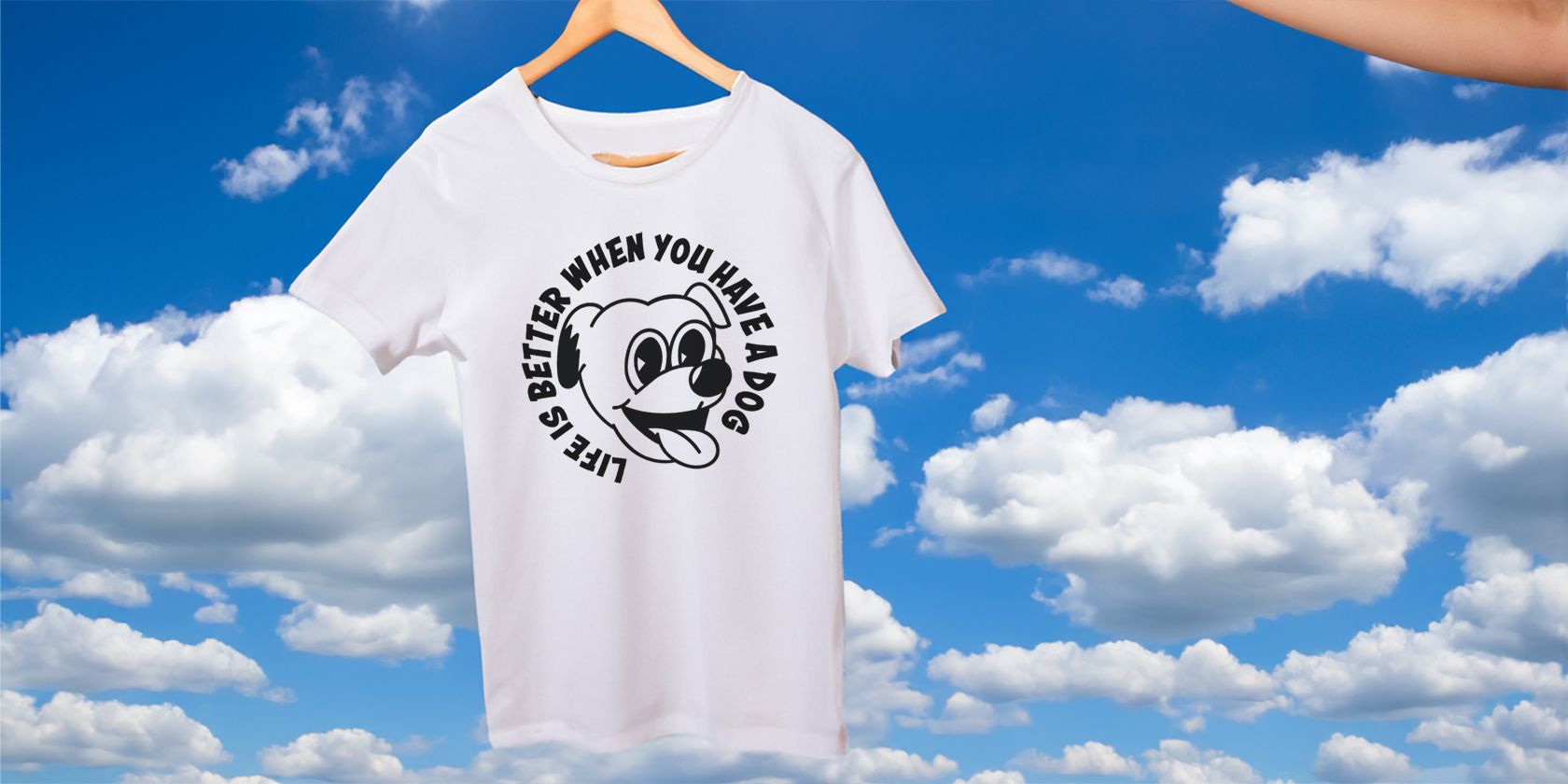 White t-shirt with dog graphic floating in blue sky.