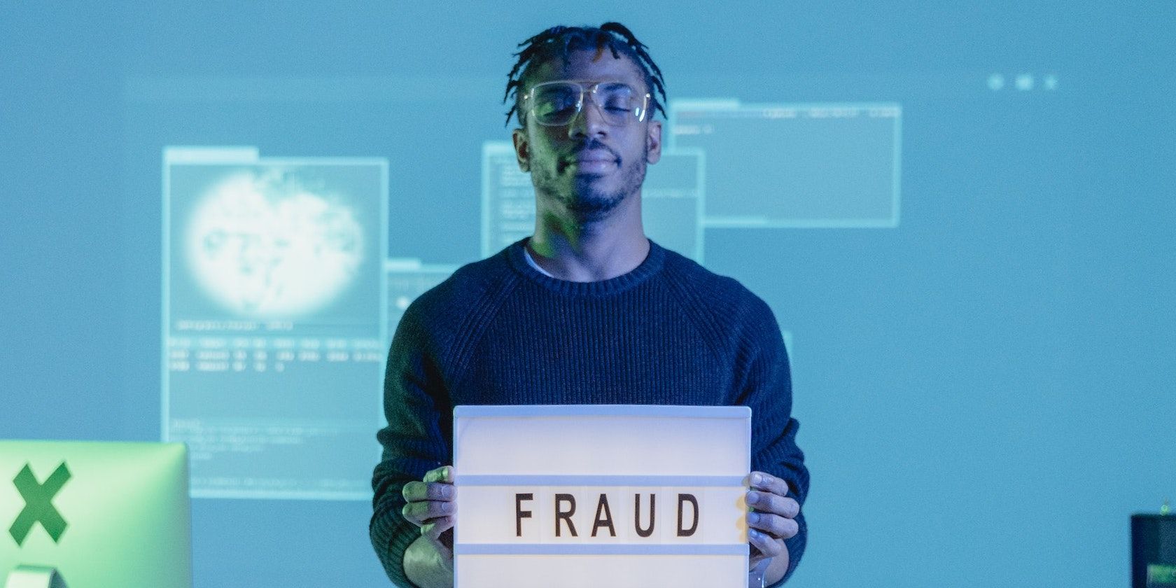 Man hold a fraud signage 
