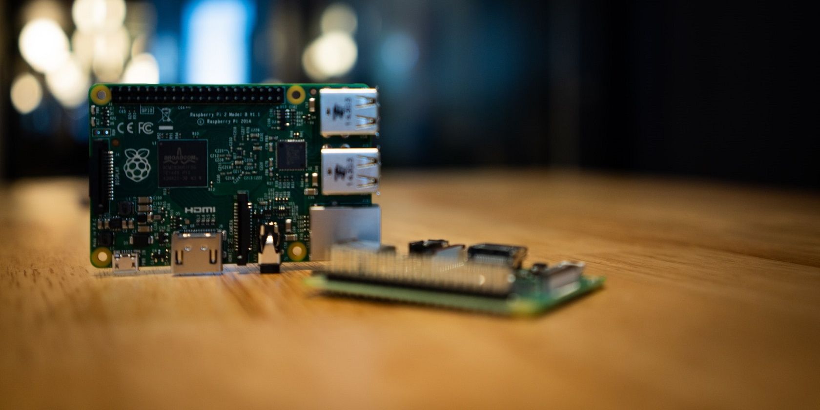 Two Raspberry Pi 2B boards on a wooden surface