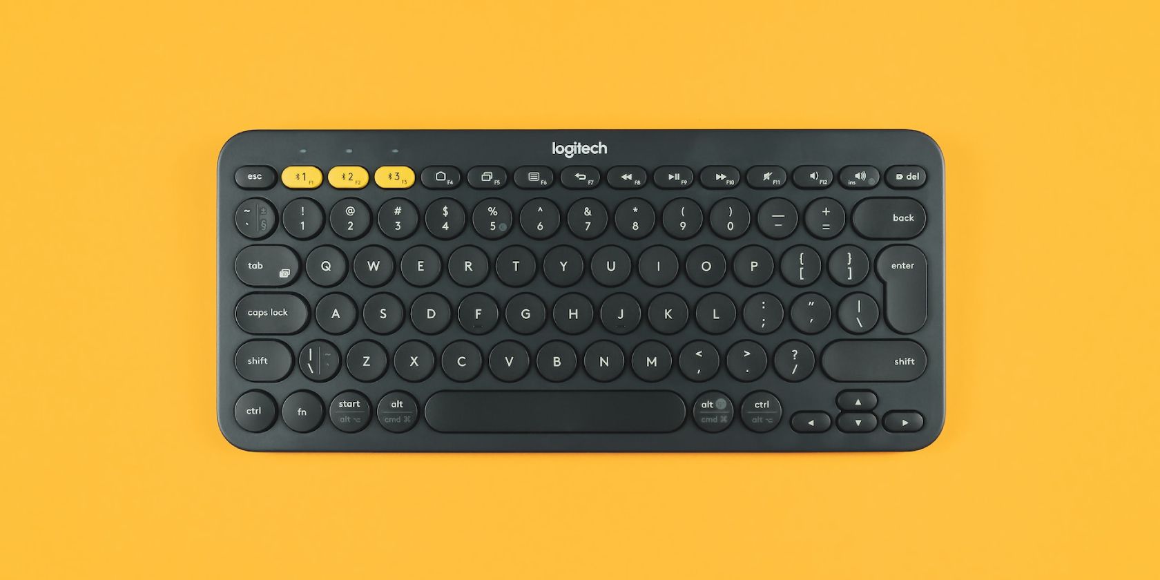 Black Logitech keyboard on yellow background