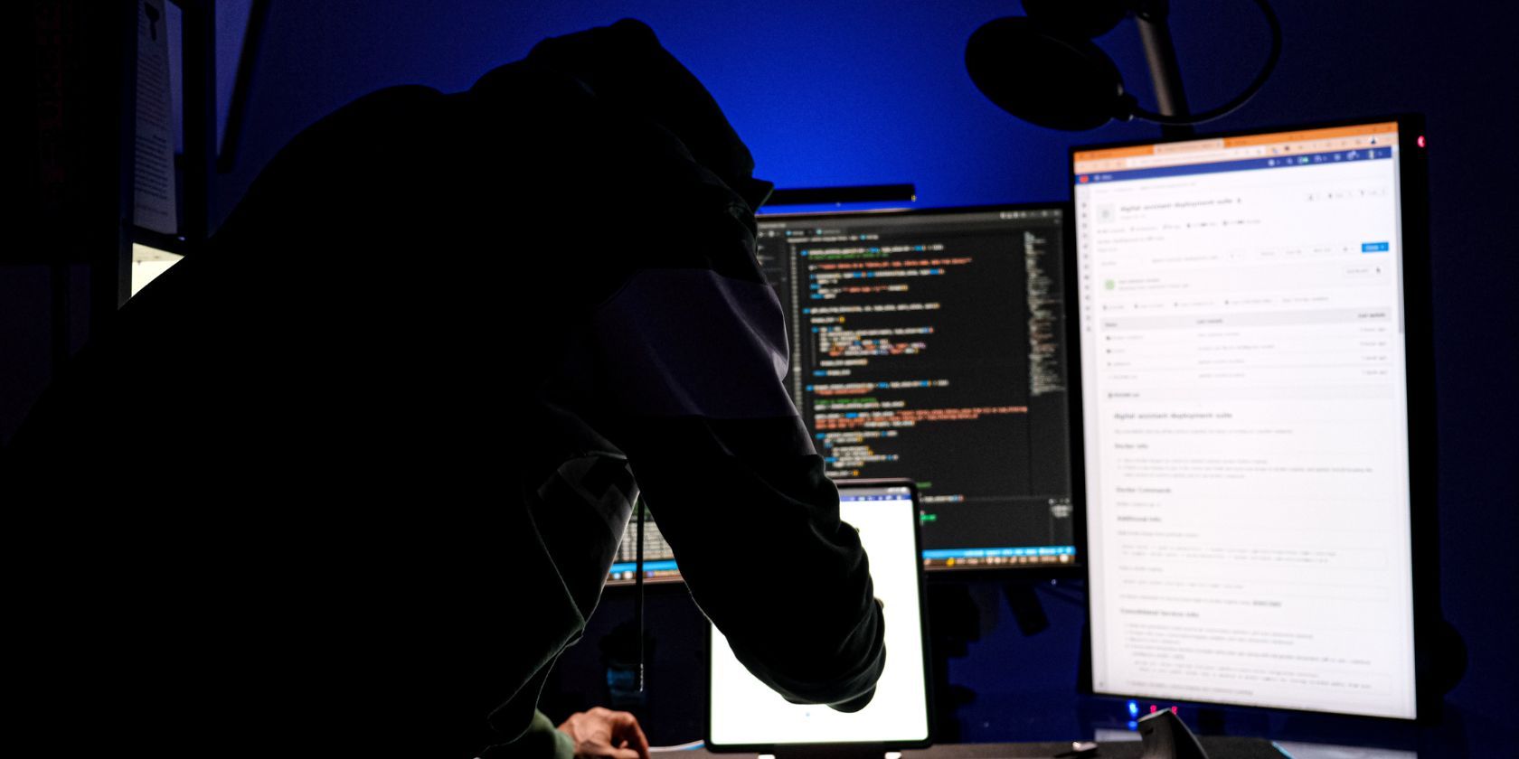 man in hoodie working on computer