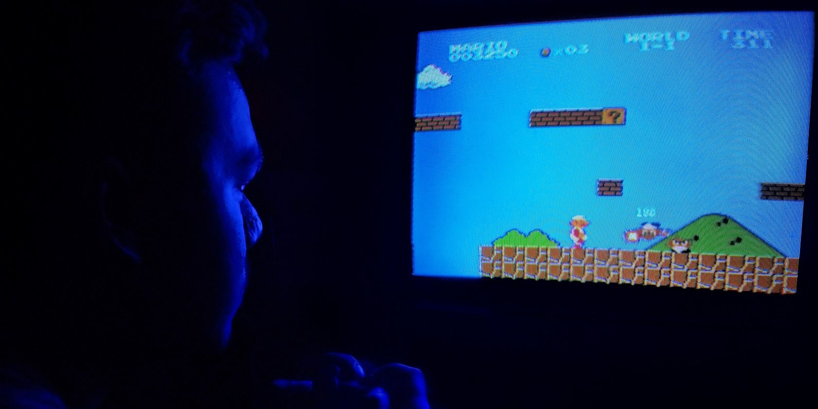 Man playing Super Mario Bros.