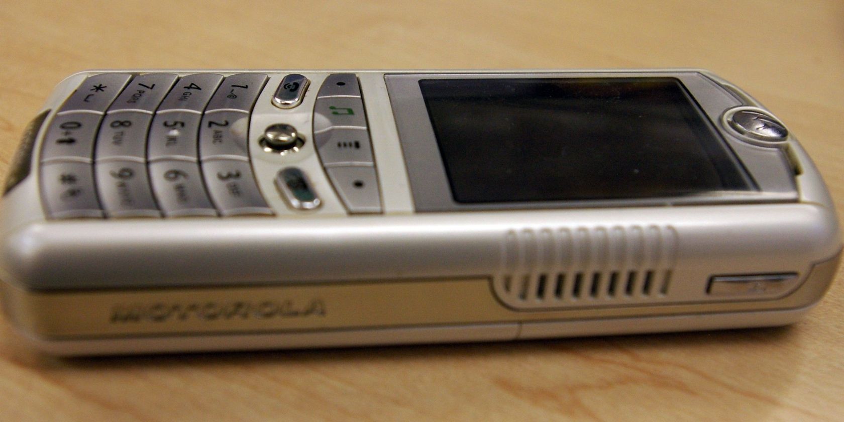 Picture of Motorola ROKR: The Motorola/Apple iTunes Phone on wooden surface