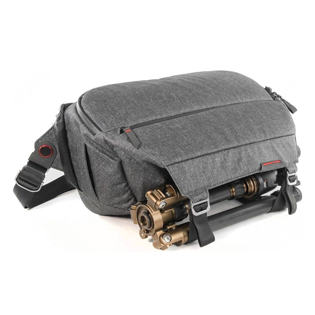 A Peak Design Everyday Sling 10L camera bag with tripod attached