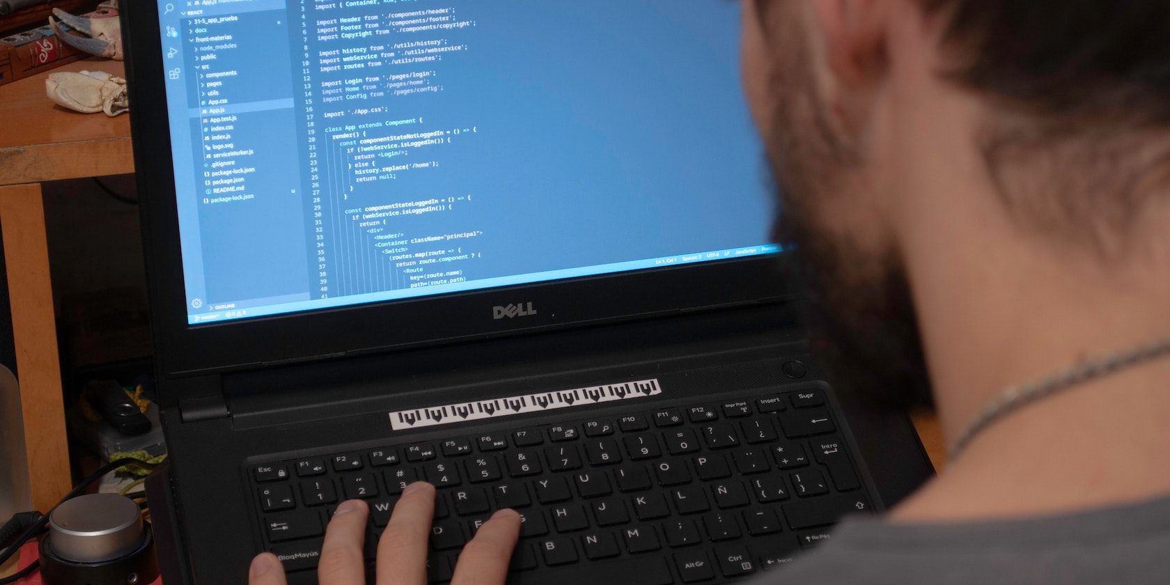 Person using a Dell PC to code