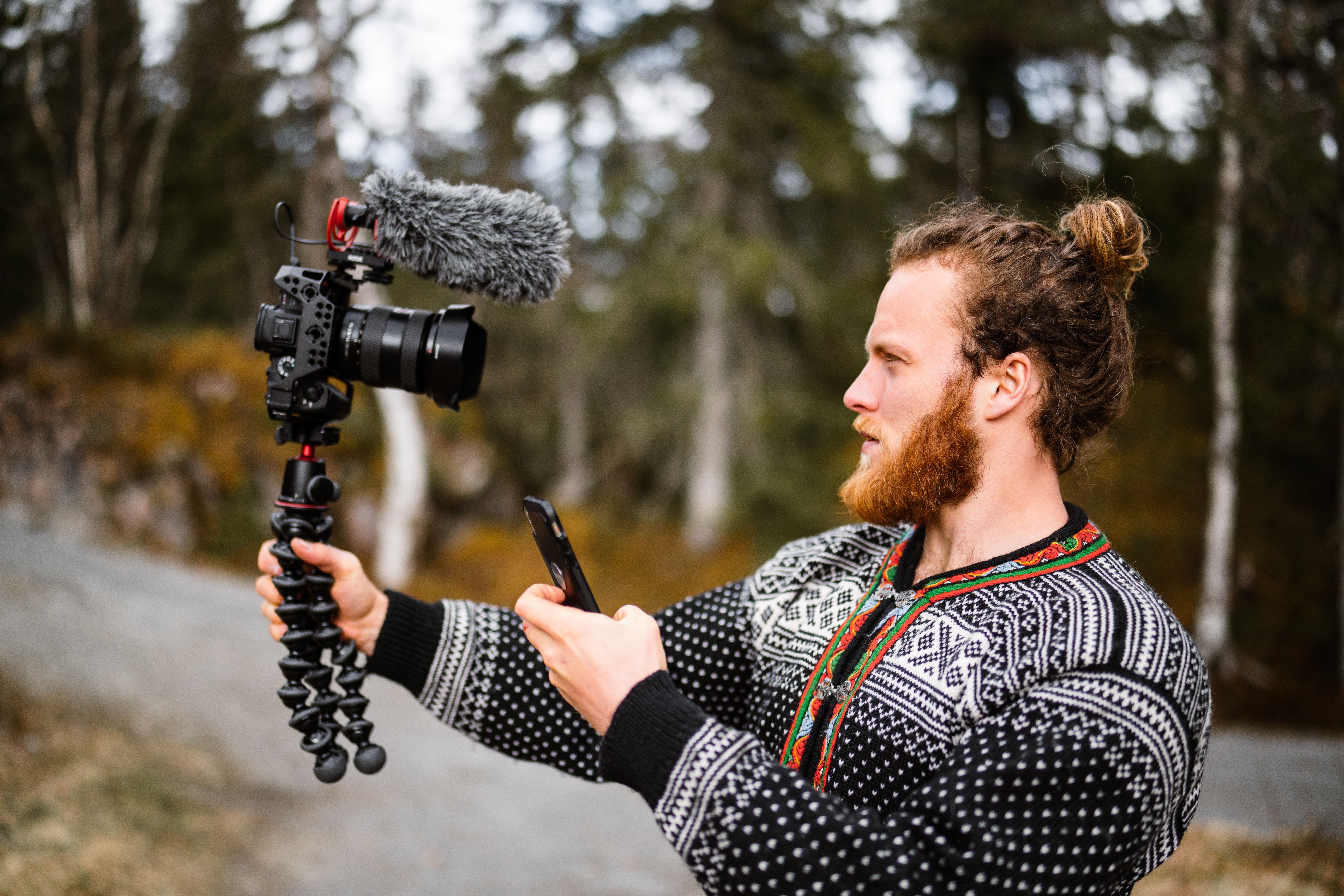 مردی که دوربینی را روی یک گوریپاد در دست گرفته و در حال انجام یک ویدیوی سلفی است