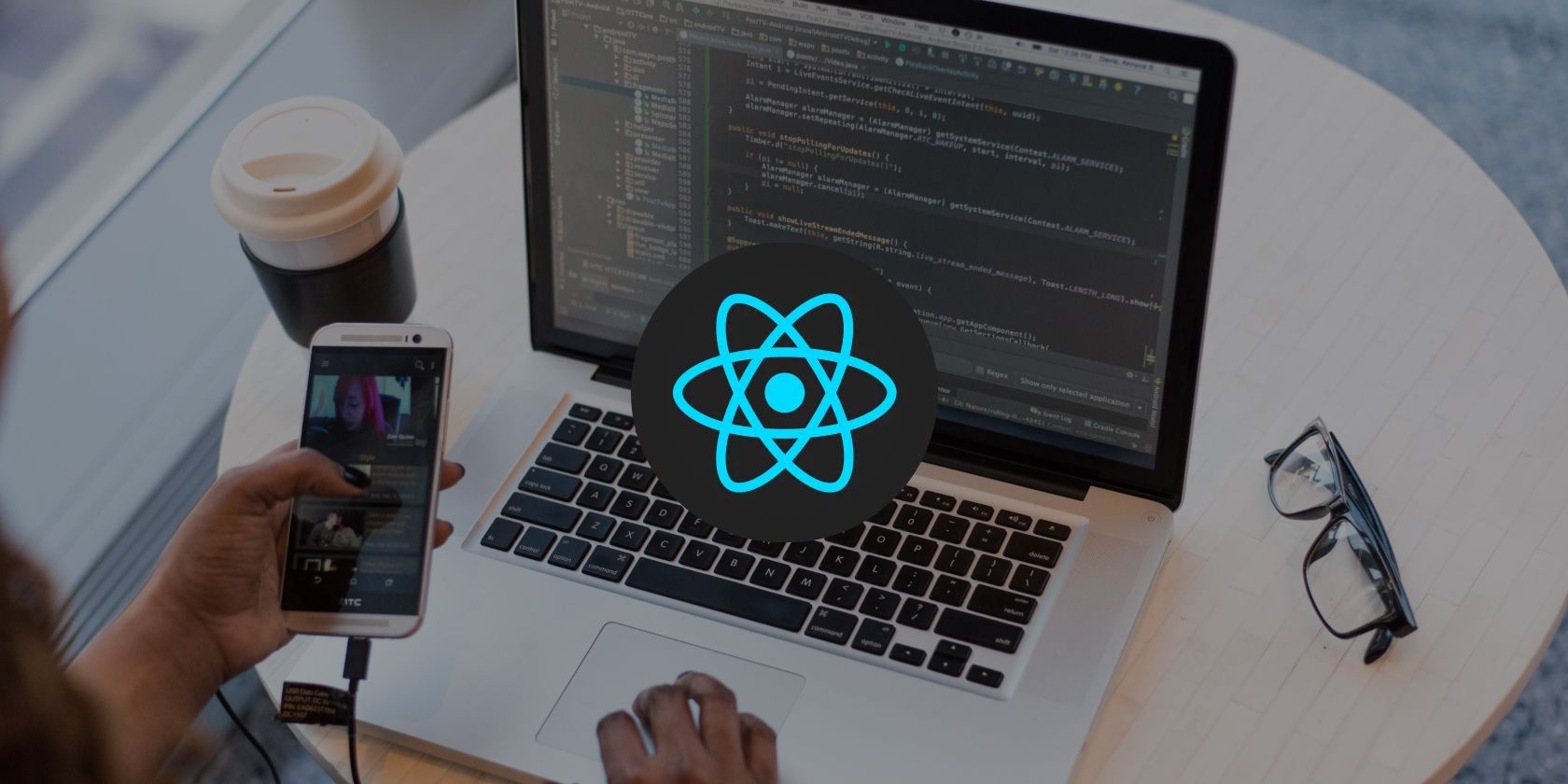 React Logo overlaying an image of someone using a laptop and a mobile phone