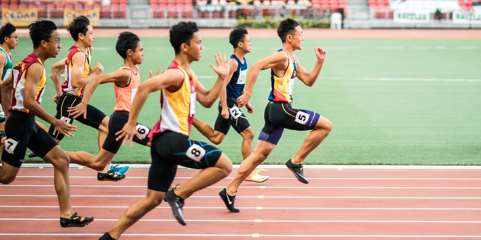 Side view of runners on a track