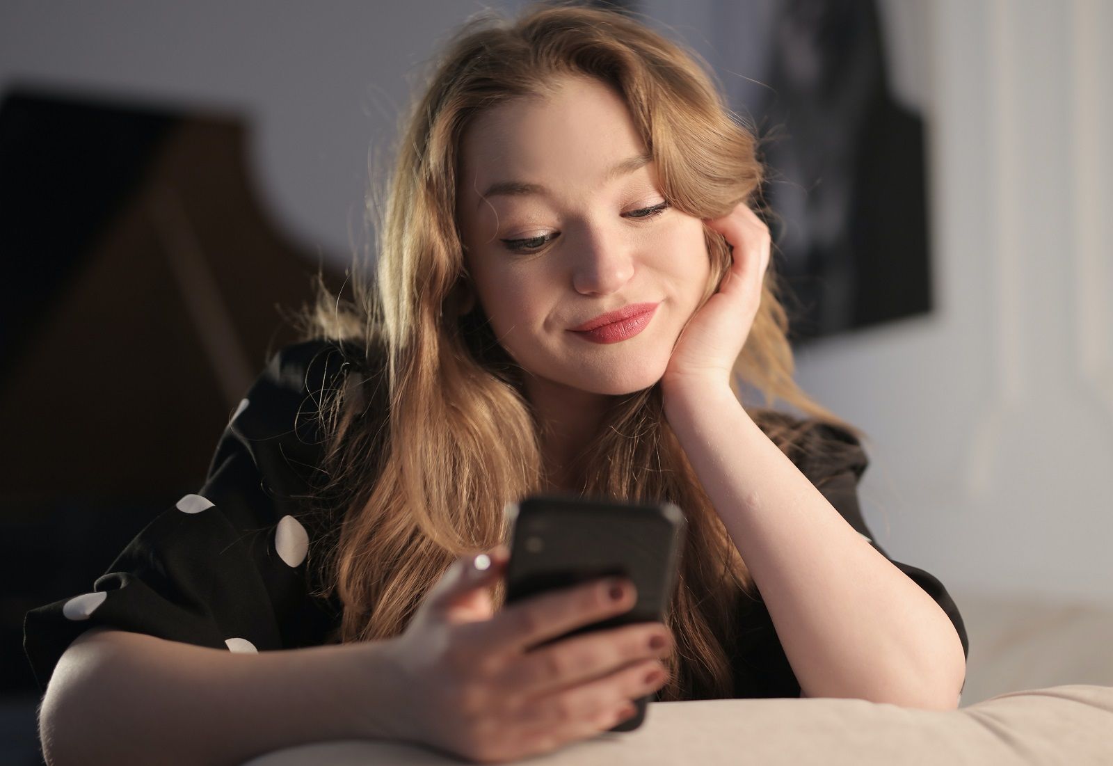 smiling woman looking at phone