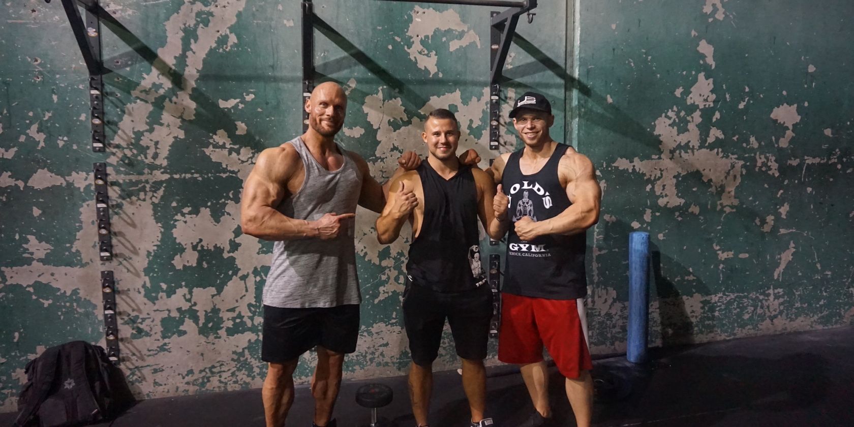 Three Big Bodybuilders in Stringers Posing at Rugged Gym
