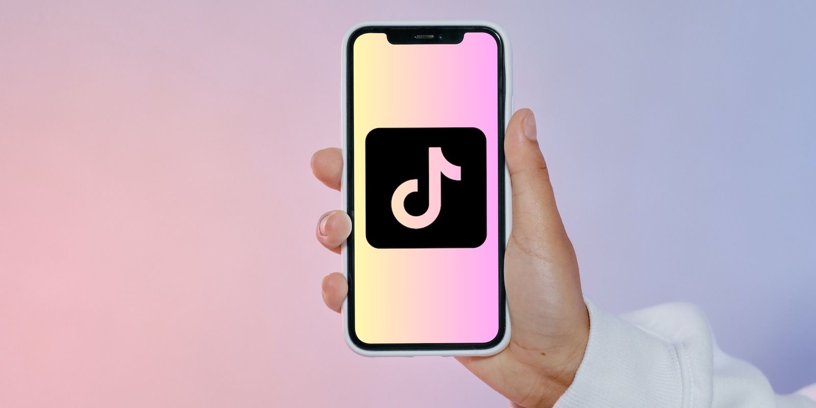 TikTok Logo on Handheld Phone on Colored Background
