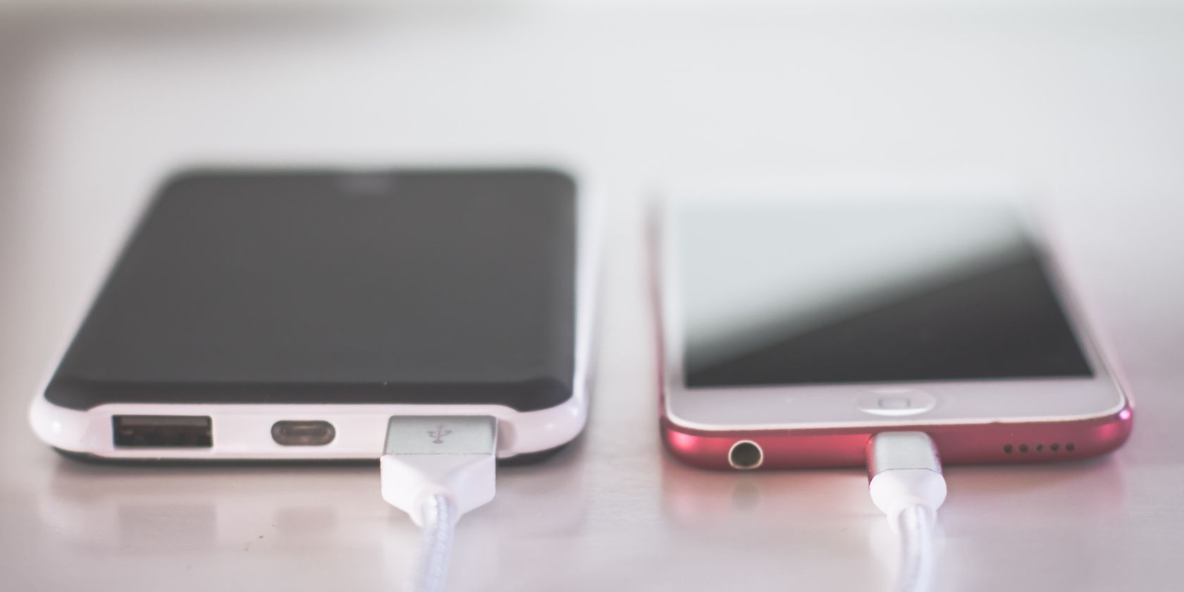 two phones charging on desk