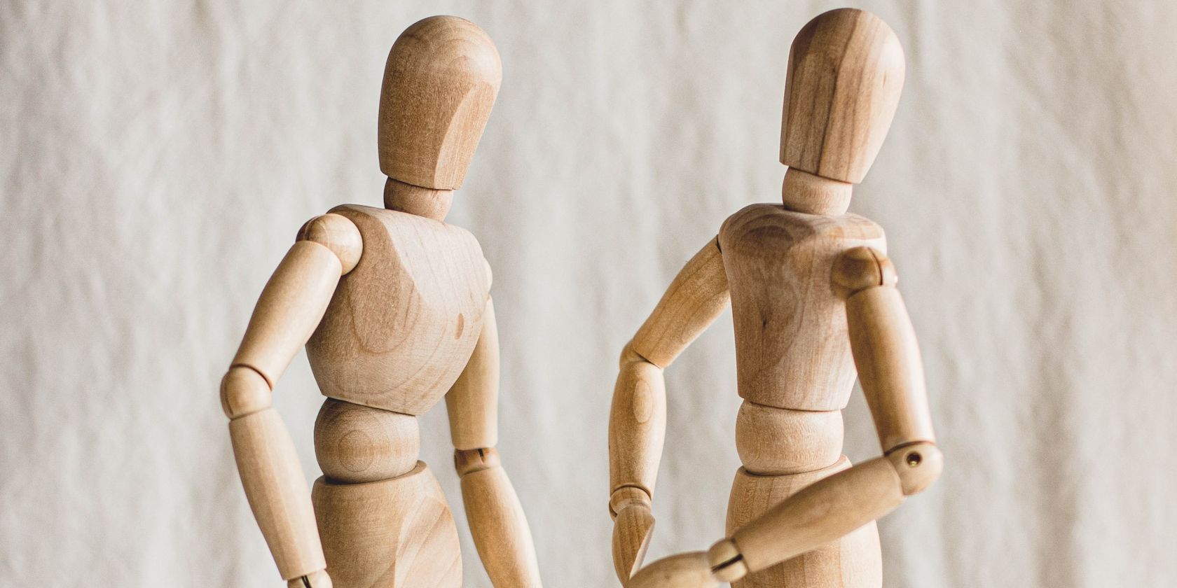 Two Wooden Figurines Set Up as Characters