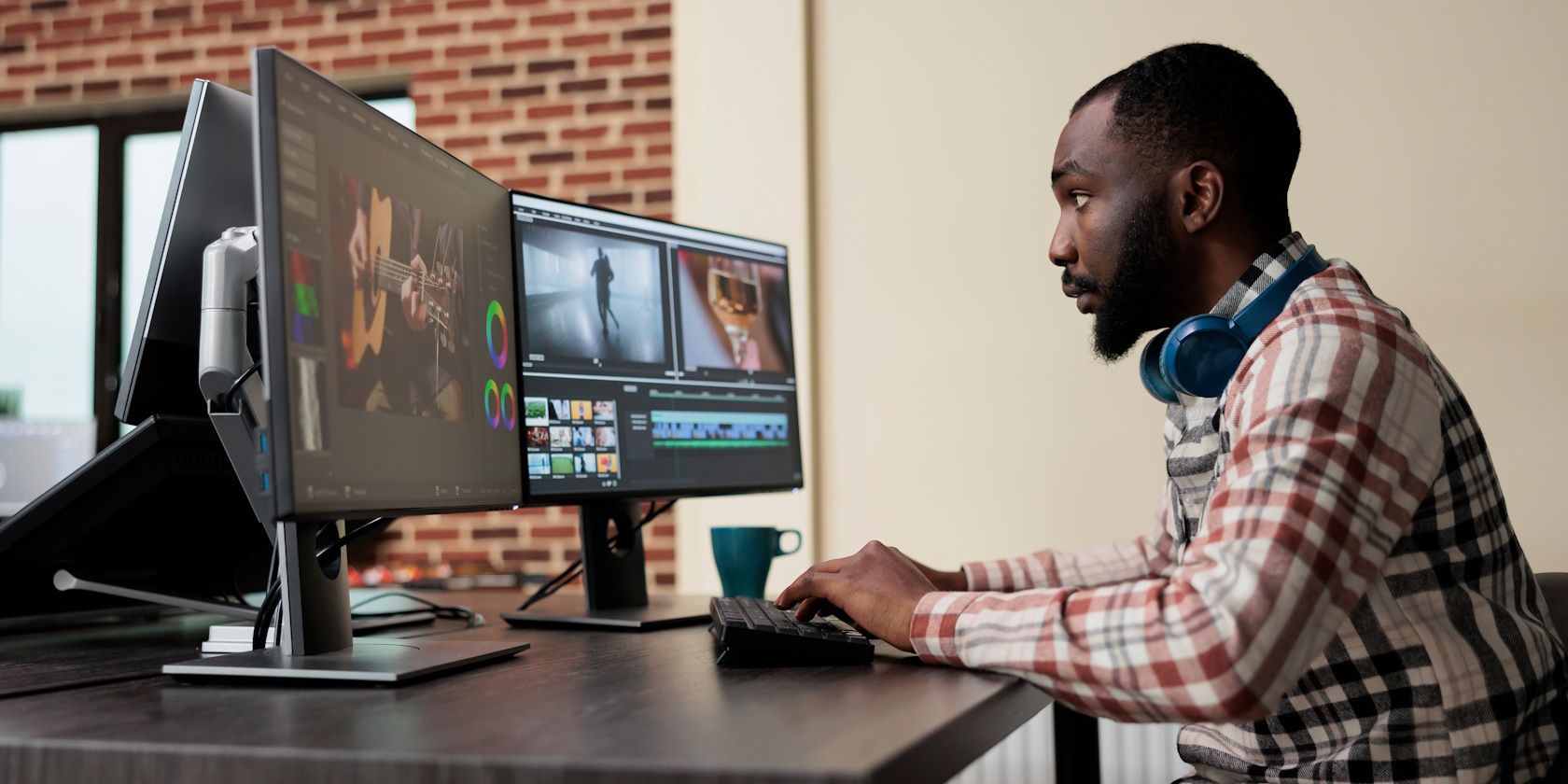 a man editing videos on his computer monitors