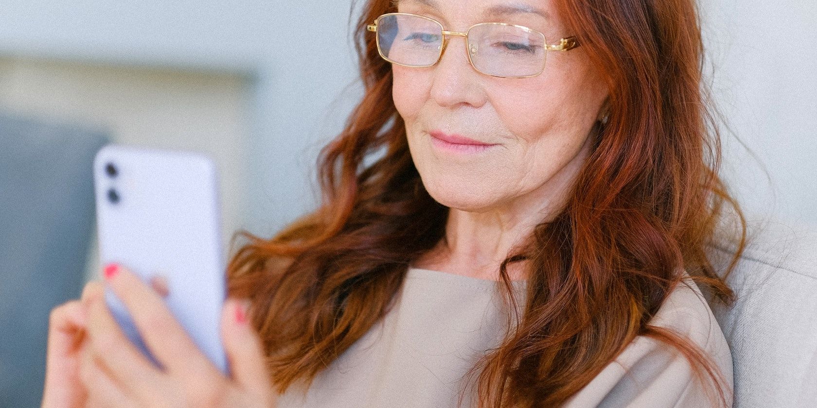 Elderly woman operating a smartphone 