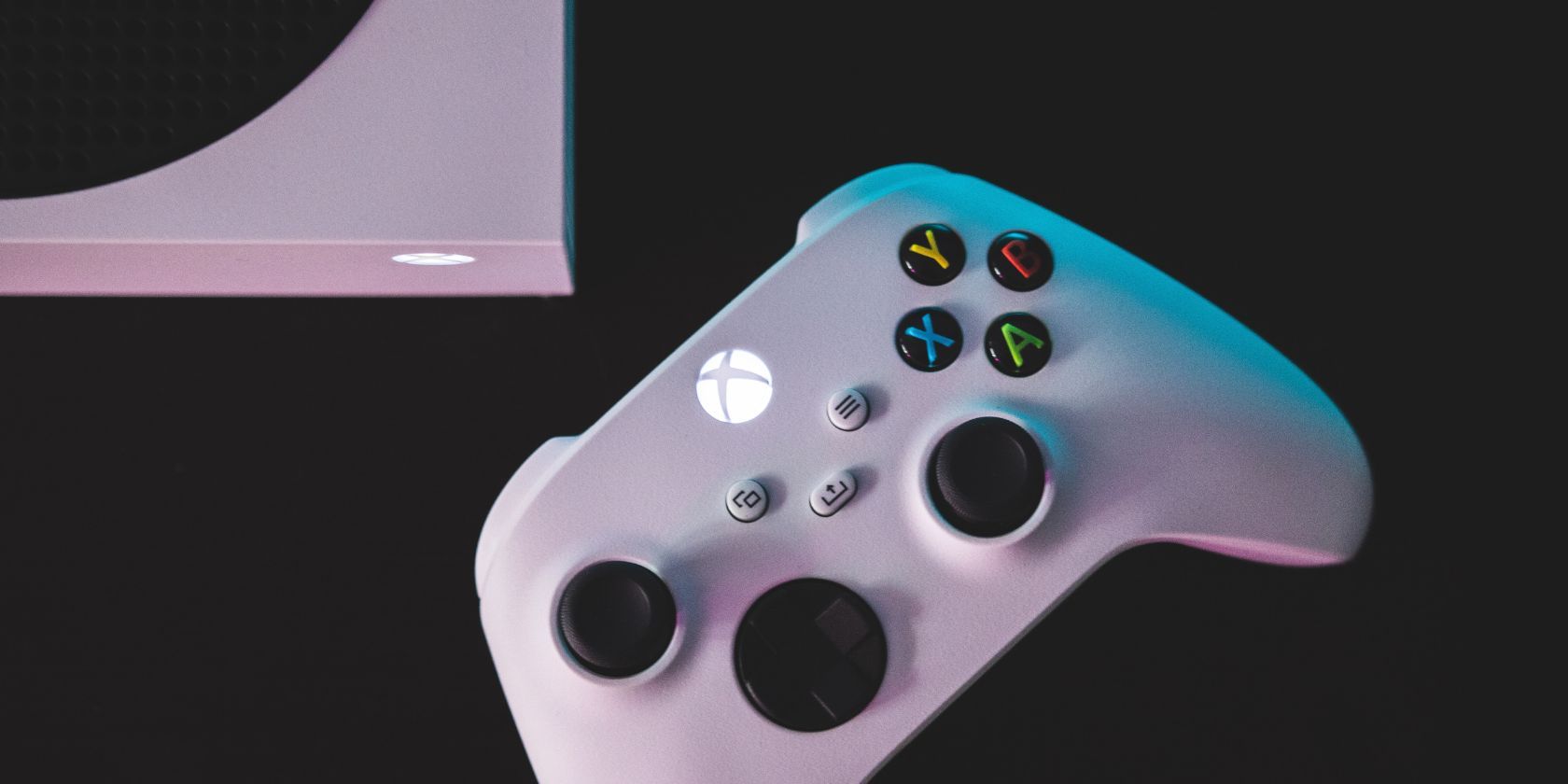 Xbox controller and console on a black surface