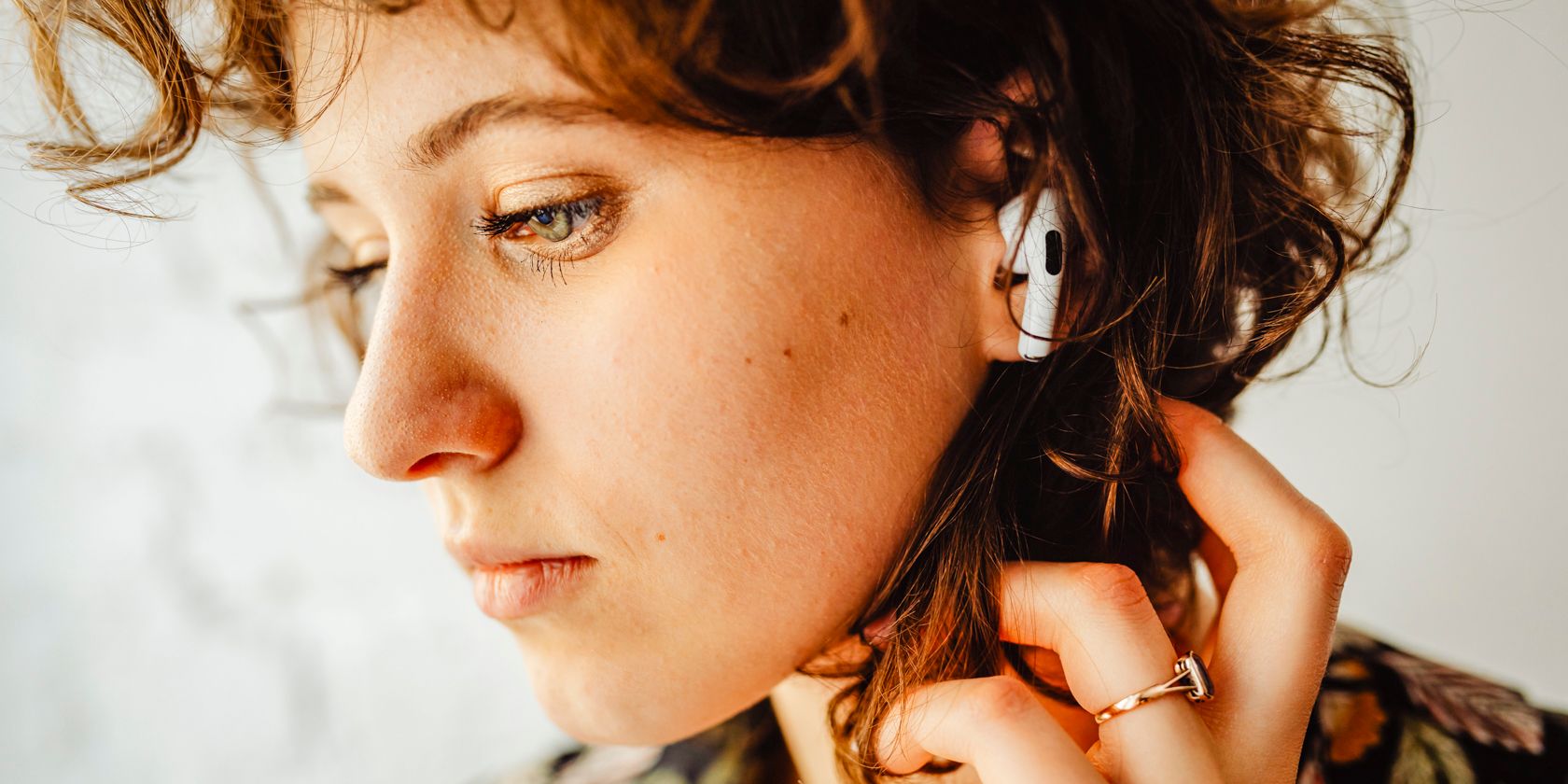 A Close-up Shot of a Woman with Airpods on Her Ear