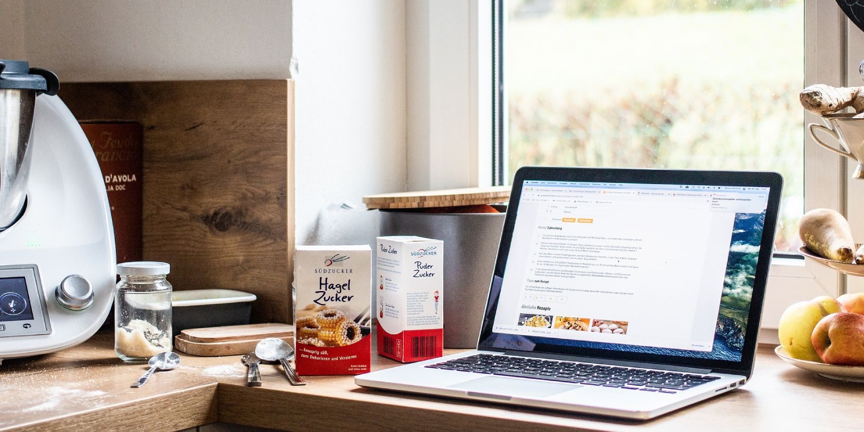 A laptop with a recipe on it that is placed on a kitchen countertop