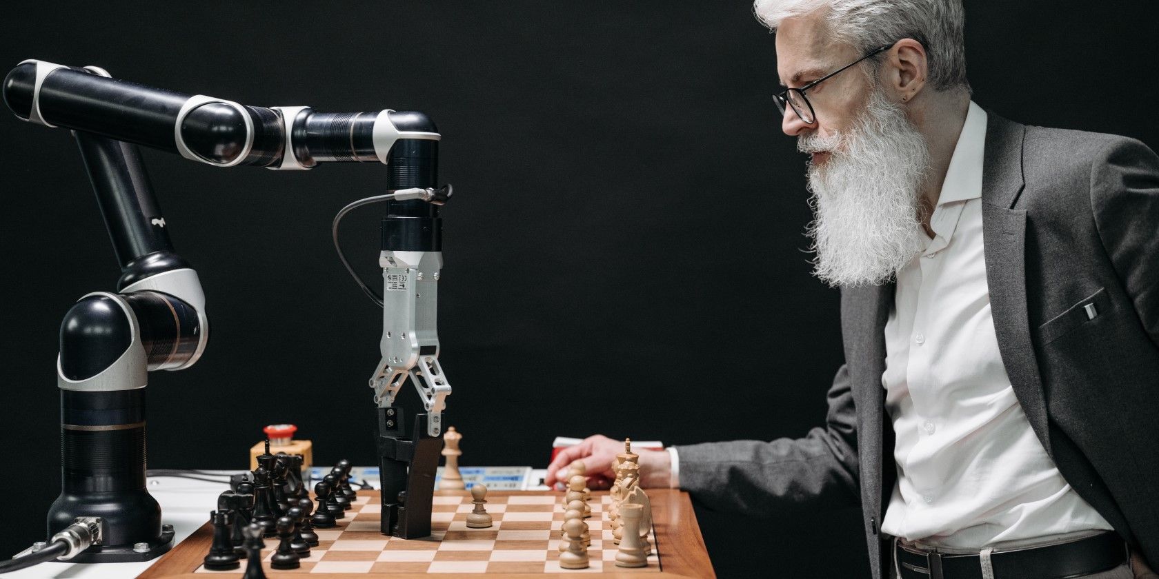 A man playing chess with an AI robot