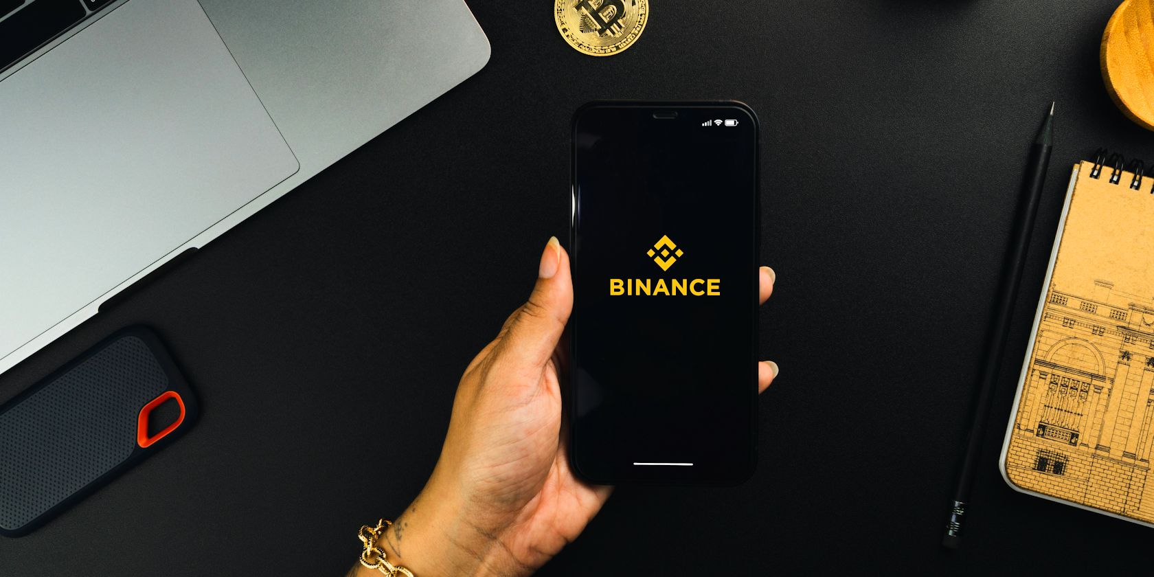 binance logo on smartphone held in womans hand feature