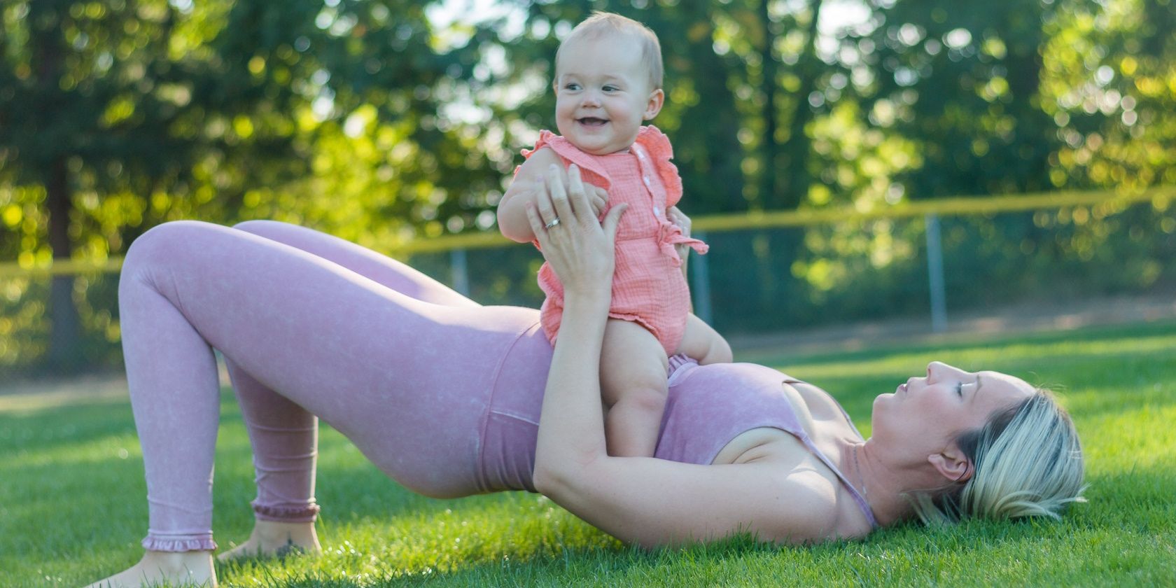 woman exercising outdoors with her baby