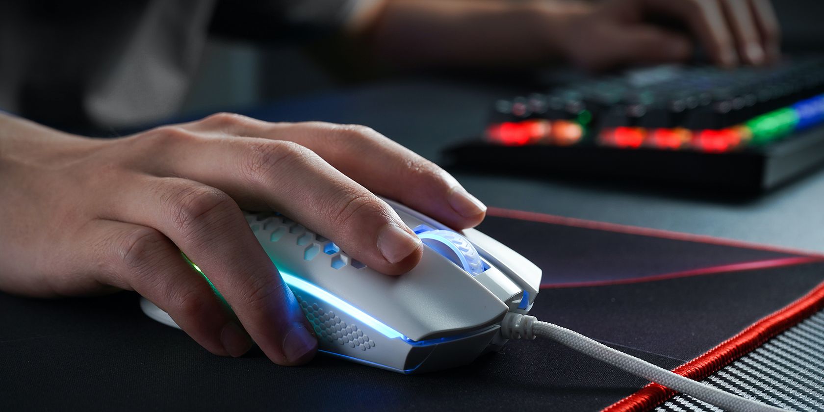 A gamer gripping his mouse atop a mouse pad