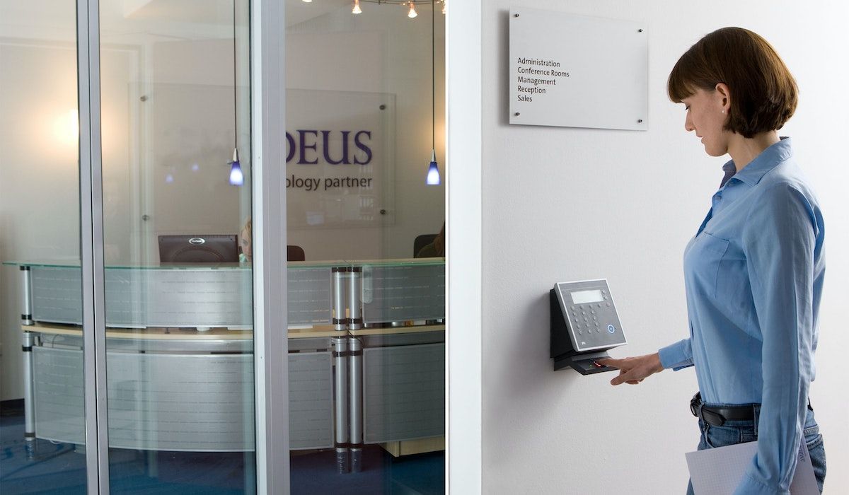 A company employee opens the door with a fingerprint scanner
